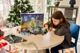 Child playing with LEGO Marvel Advent Calendar.