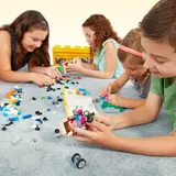 Kids building LEGO on floor.