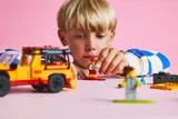 Child playing with lifeguard minifigure.