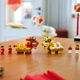 LEGO lion dancers and minifigures on a table.