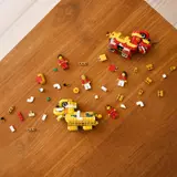 Deconstructed LEGO lion dance figures with bricks.