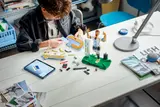Boy building LEGO Messi set.