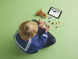 Overhead view of boy building LEGO T. rex.