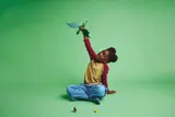 Child plays with flying dragon.