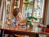 Child playing with Ninjago mech and dragon.