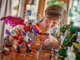 Child playing with Ninjago dragon.