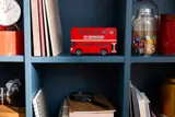 LEGO bus on a bookshelf.