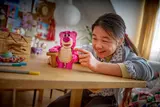 Girl playing with Lotso.