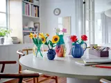 Multiple LEGO botanical sets on a table.