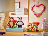 Bears next to a birdhouse set.