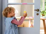 Child holding transparent star ornament.