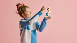 Child holding LEGO unicorn.