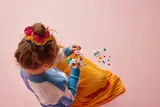 Child playing with LEGO unicorn.