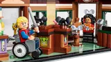 Minifigure in wheelchair inside shop.