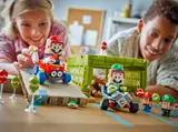 Kids playing with Mario Kart LEGO sets.