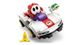 Shy Guy 'throwing' green shell from kart.