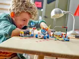 Child playing with LEGO Mario Kart set.