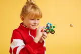 Child playing with Yoshi bike.