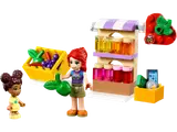 LEGO Friends market stall scene with two minifigures, fruit crate, and bottled goods.