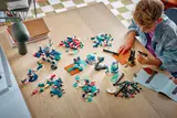 Boy building LEGO Mars Mission set with sorted bricks.