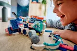 Boy excitedly playing with LEGO Mars Rover.