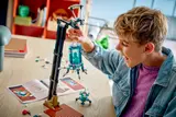 Boy playing with LEGO drop pod tower.