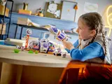 Girl playing with LEGO Mars rocket.