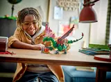 Child playing with LEGO dragon.