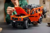 Woman opening hood and doors of LEGO Technic G 500.