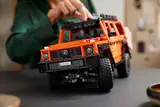 Woman adjusting roof rack of LEGO Technic G 500.