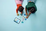 Overhead view of LEGO building with tablet.