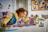 Child smiling while interacting with LEGO set.