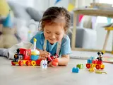 Child playing with assembled train.