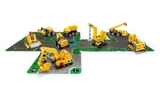 Eight Technic vehicles on a construction play mat.