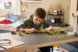 Child playing with Technic construction vehicles.