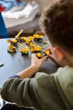 Child examining a Technic dump truck.