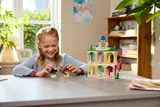 Girl playing with castle and figures.