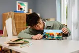 Person inspecting assembled LEGO Minecraft set.