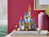 LEGO Disney Castle on books against a red wall.