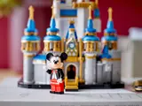 Mickey Mouse minifigure waving with castle blurred.