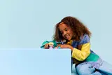 Child playing with LEGO Disney figures.