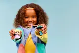 Child presents LEGO Disney figures.