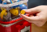 Hand holding LEGO coin.