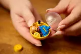 Opening a LEGO minifigure capsule.