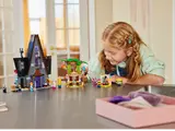 Girl playing with full LEGO set.