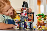 Close-up of girl playing with mansion interior.