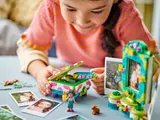 Girl putting bracelet in LEGO jewelry box.