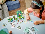 Child playing with Encanto LEGO set.