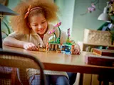 Child playing with split flowerpot.