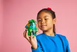 Child holding green island tower.